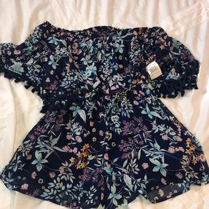 Never worn. Romper off shoulder with tassels.